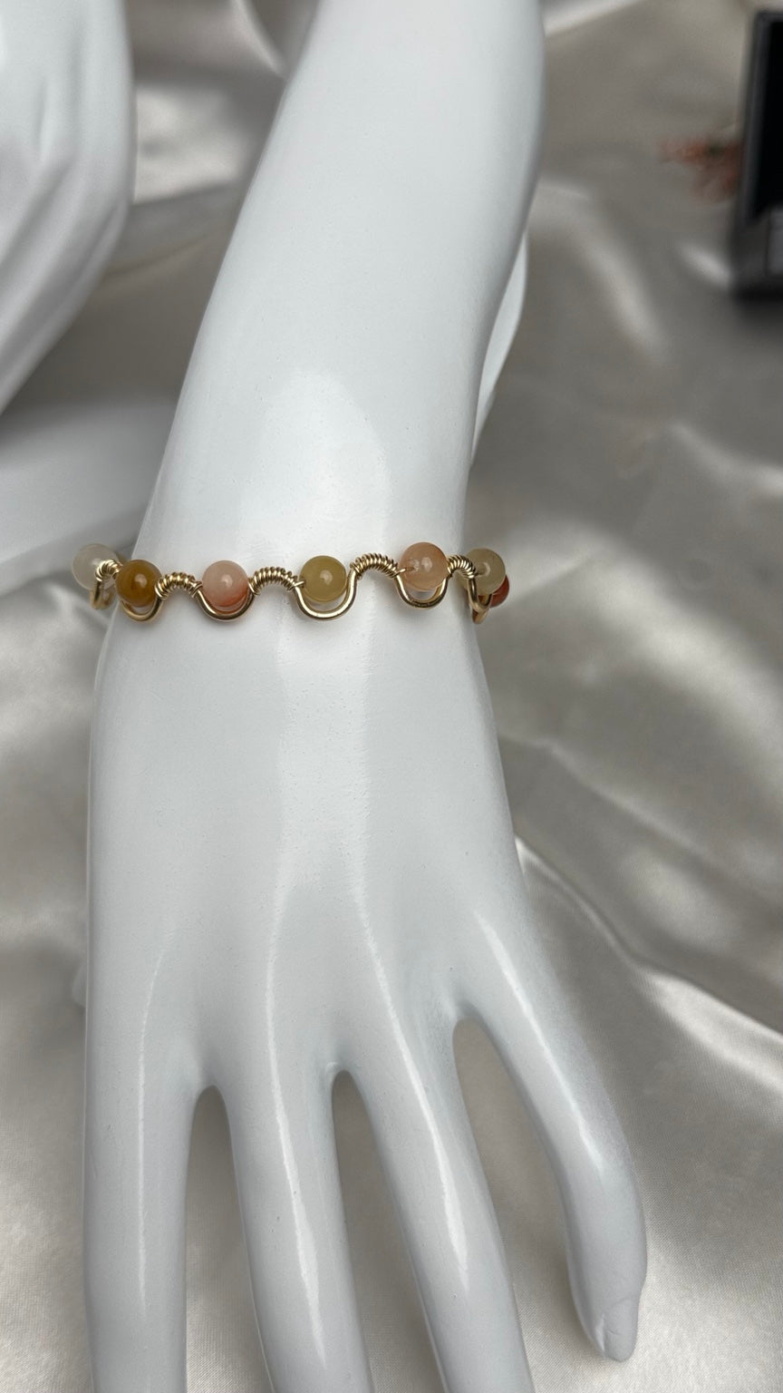 Handmade gold wire-wrapped bracelet with soft pastel stone beads